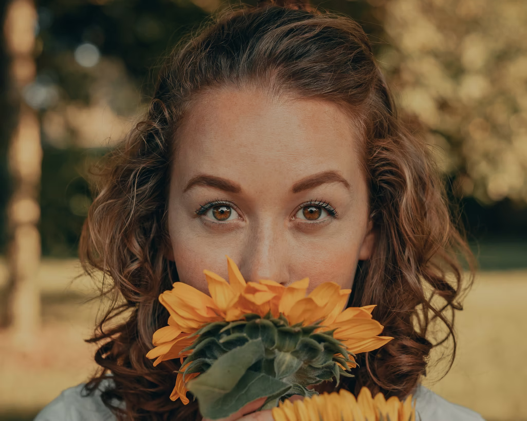 Woman smelling a sunflower